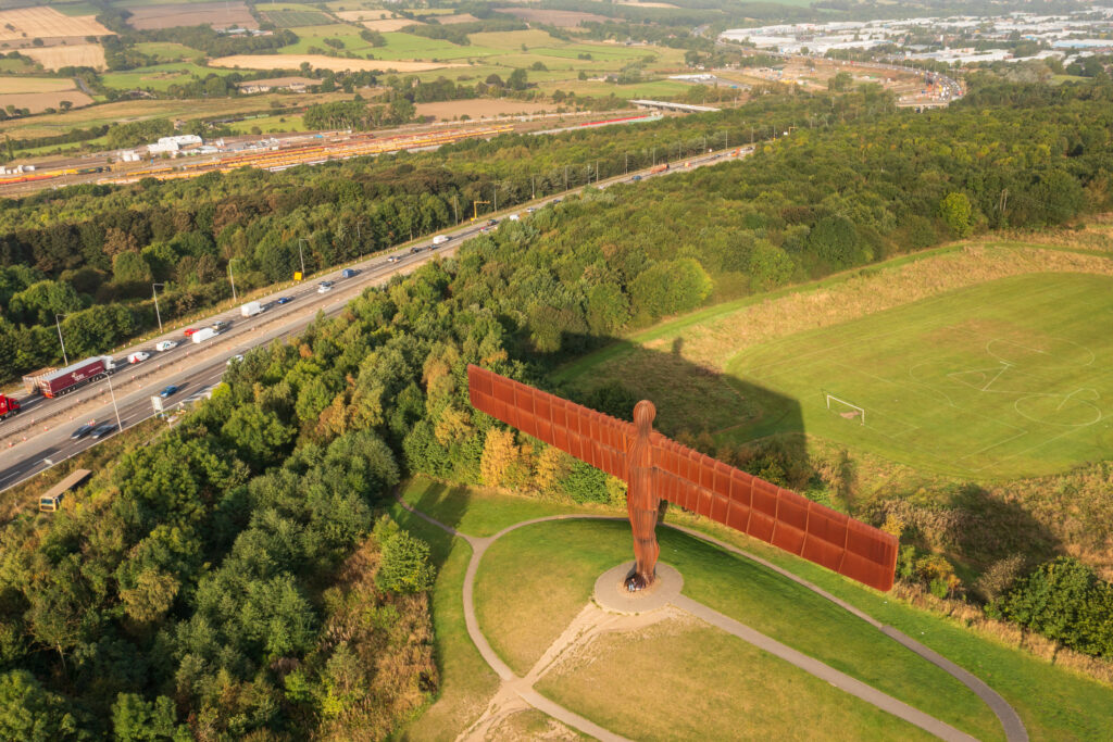 England, Tyne and Wear, Gateshead. Aerial (drone) view of the iconic Angel of the North statue by Antony Gormley. The 'Angel', built on a a former colliery pit head bath site, is one of the worlds most viewed work of art with over 33 million viewers each year.